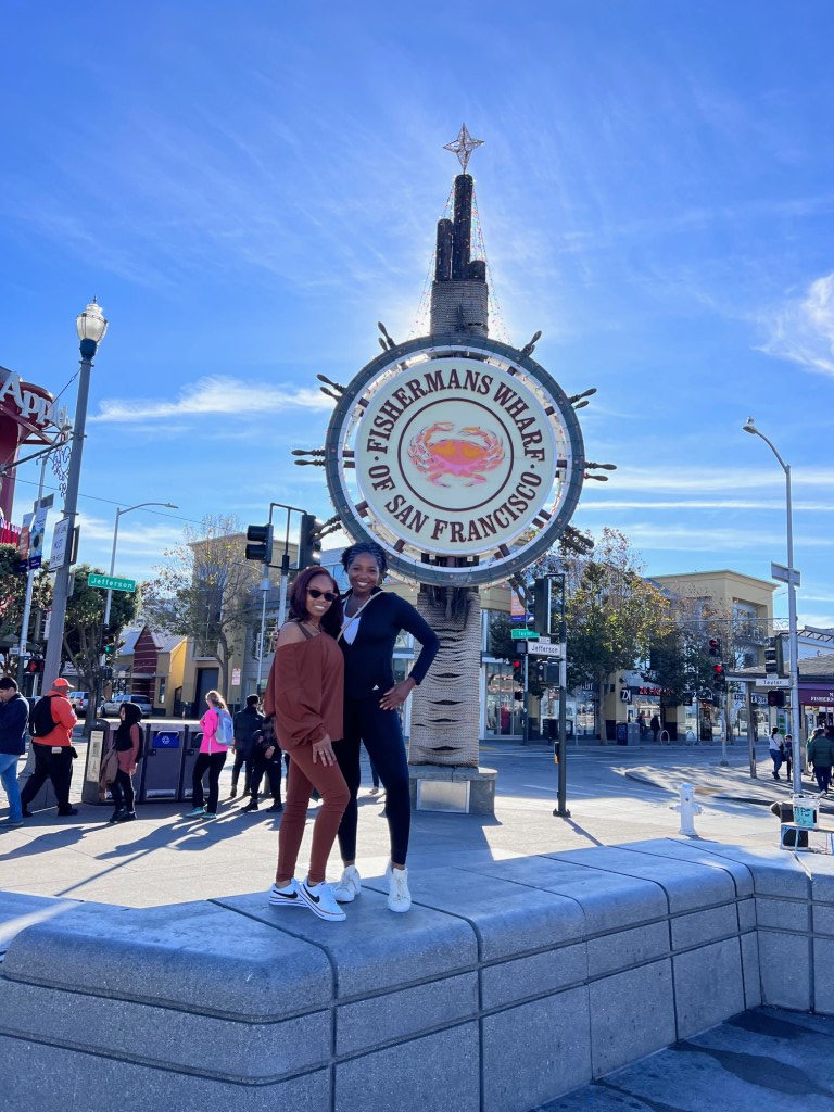 Donna and Chelsea in front of the iconic Fisherman's Wharf sign.